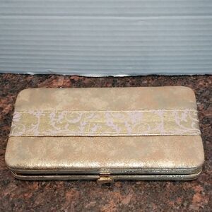 Tarte Gold and Lavender Clutch Holding "Pin Up Girl" Palette.